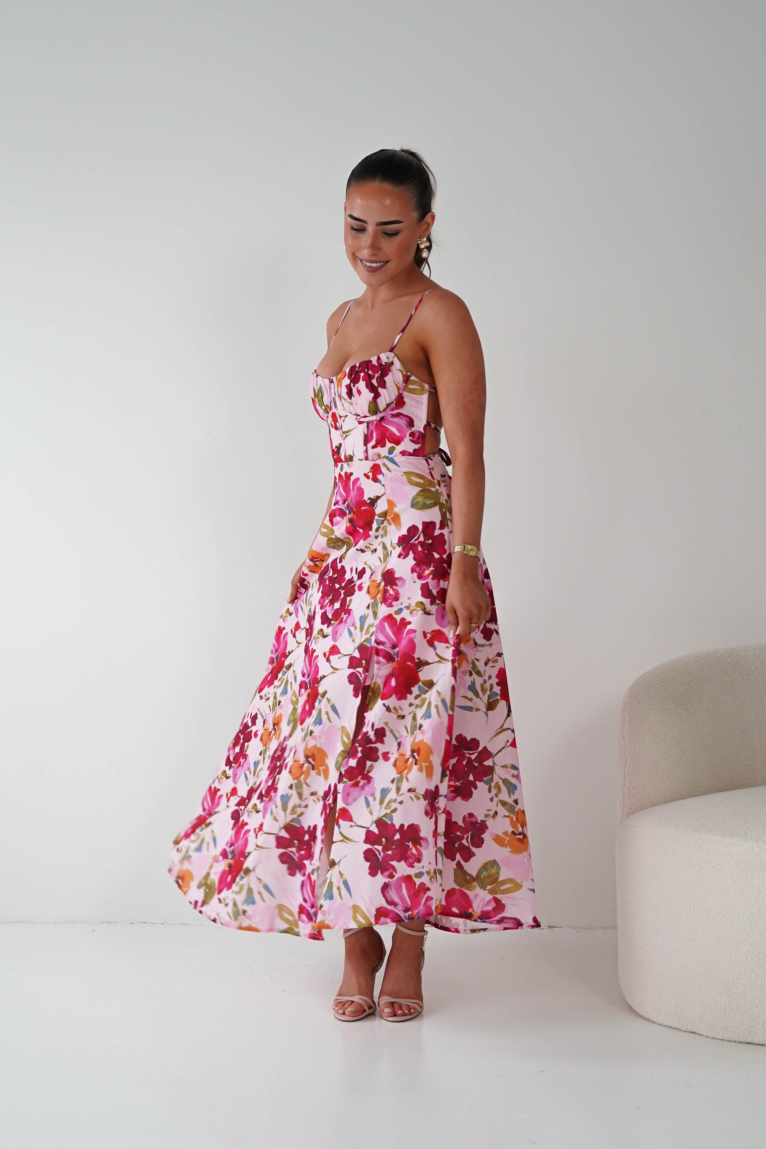 Woman wearing a floral dress against a white background