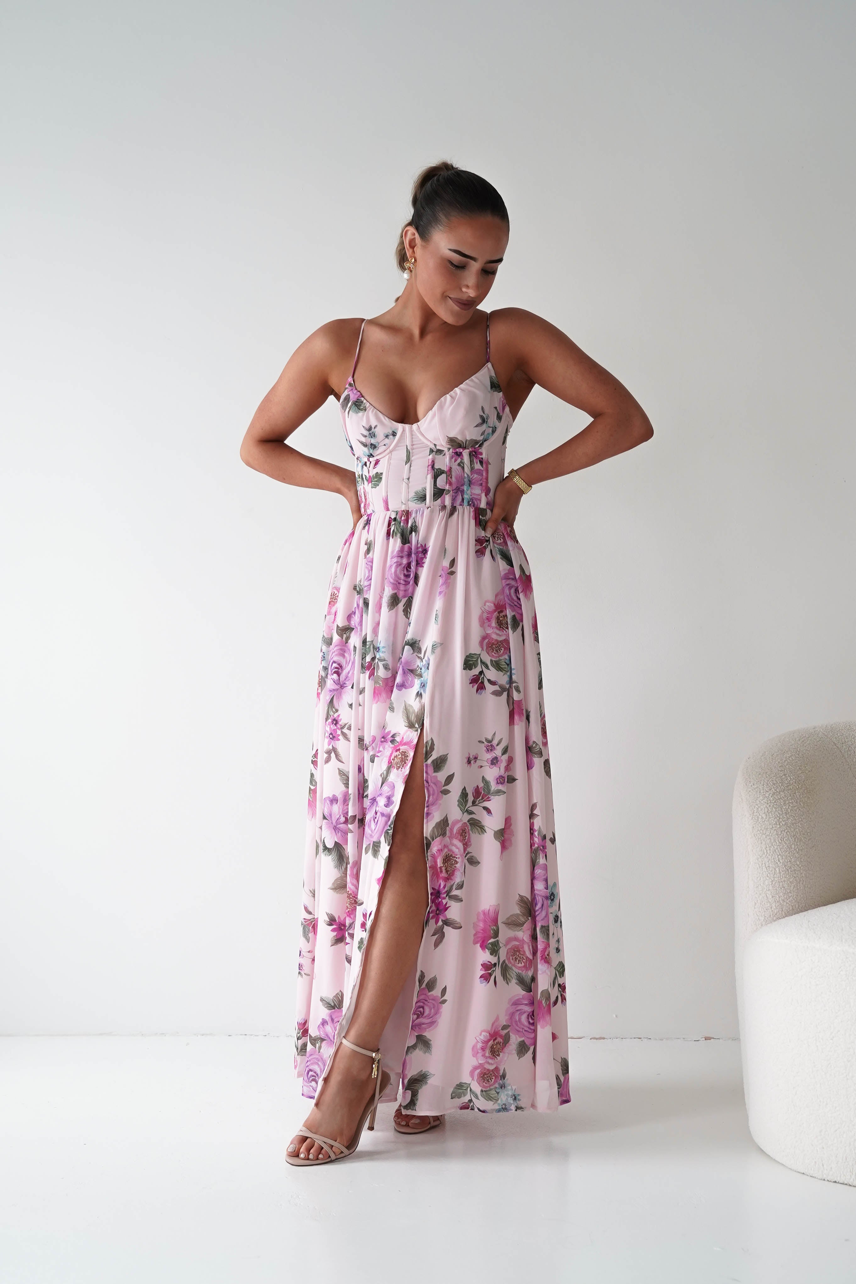 Woman wearing a floral dress with a white background